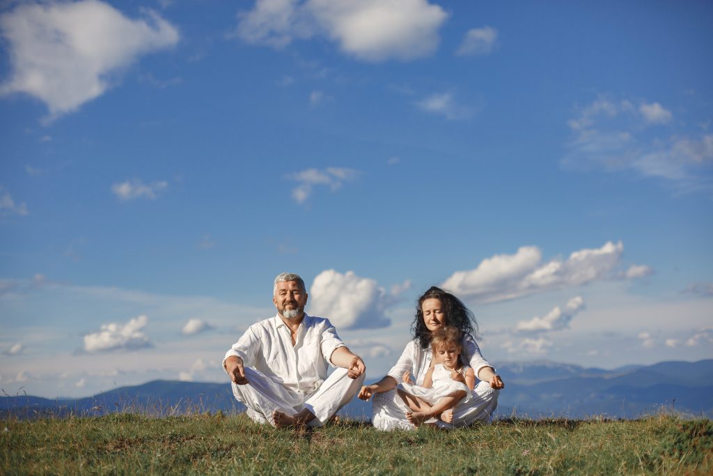 grandparents meditating with children